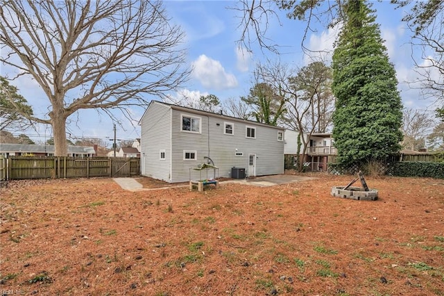 rear view of house with a yard, cooling unit, and a patio area