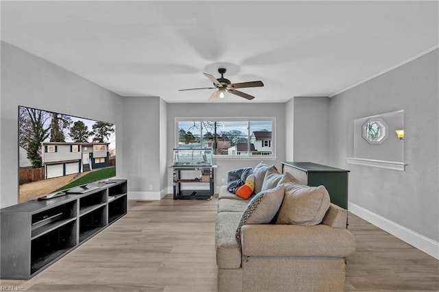 living room with wood-type flooring and ceiling fan