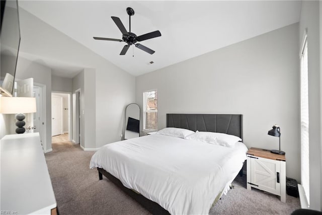 carpeted bedroom with vaulted ceiling and ceiling fan