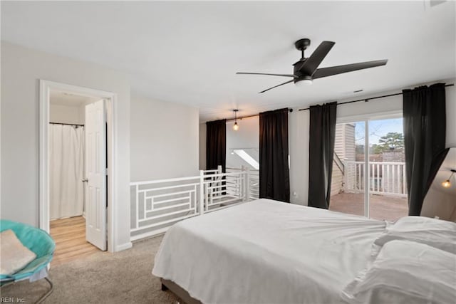 bedroom with light colored carpet, access to exterior, and ceiling fan