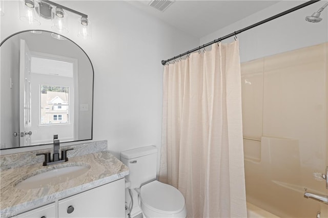 bathroom featuring vanity, curtained shower, and toilet