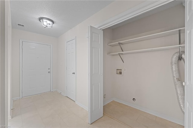 laundry area with washer hookup and a textured ceiling