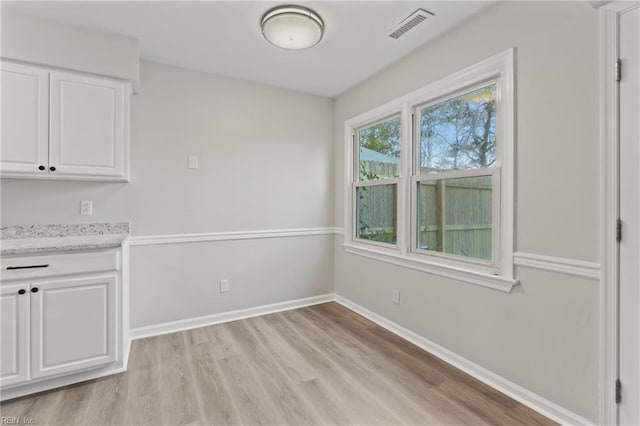 unfurnished dining area with light hardwood / wood-style floors