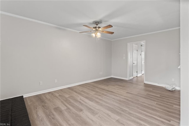 spare room with crown molding, ceiling fan, and light wood-type flooring