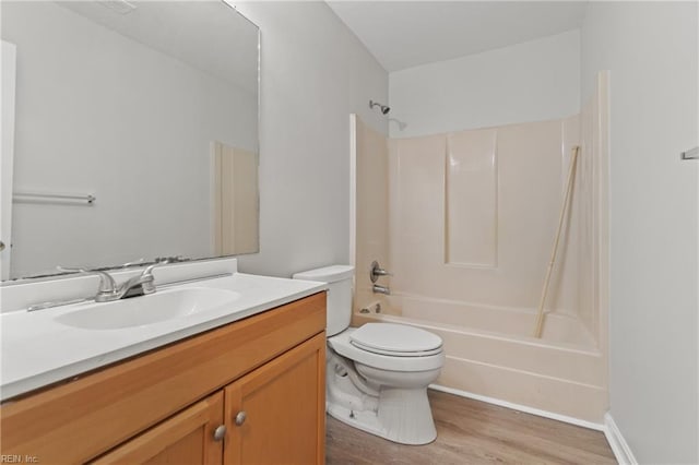 full bathroom featuring vanity, hardwood / wood-style floors,  shower combination, and toilet