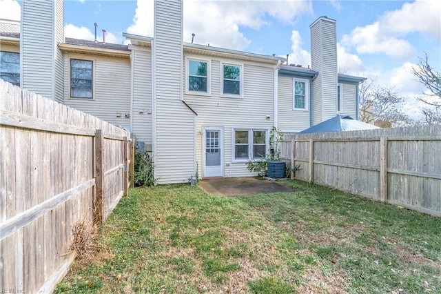 rear view of property with a patio, central AC unit, and a lawn