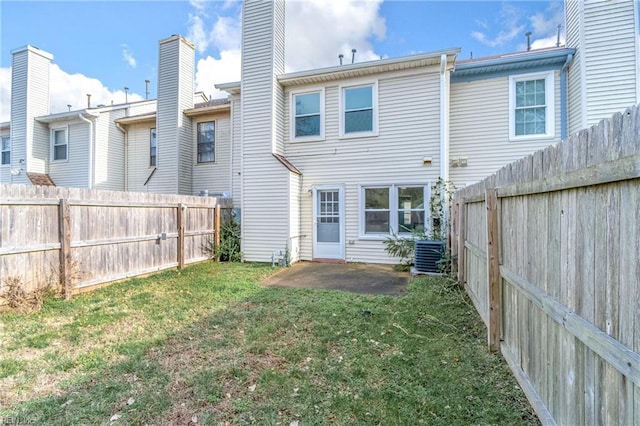 back of property featuring a patio, a yard, and central AC unit