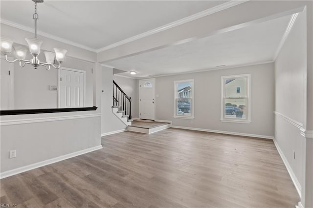 interior space with an inviting chandelier, hardwood / wood-style floors, and crown molding