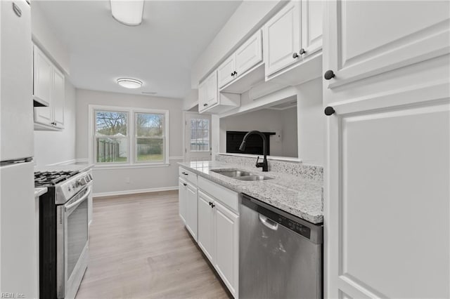 kitchen with white cabinetry, appliances with stainless steel finishes, and sink