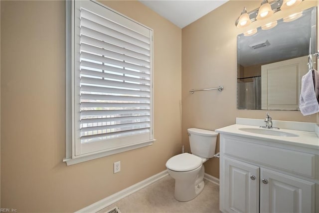 bathroom with vanity, tile patterned flooring, curtained shower, and toilet