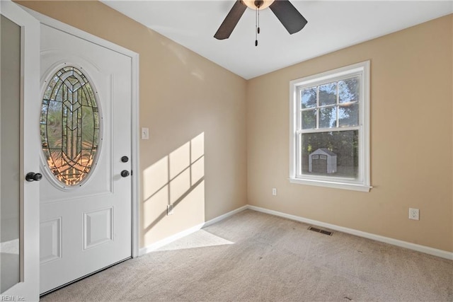 entryway featuring light colored carpet and ceiling fan