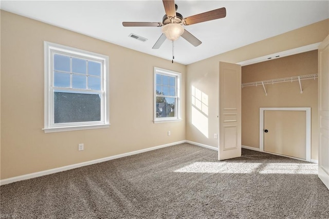 unfurnished bedroom featuring carpet floors, a closet, and ceiling fan