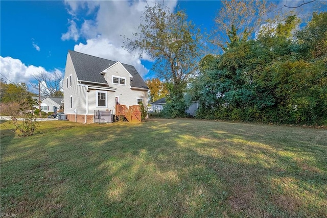 back of house with a wooden deck and a yard