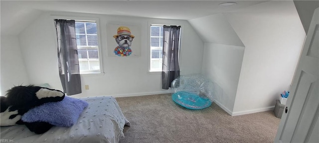 bedroom featuring carpet floors, lofted ceiling, and baseboards