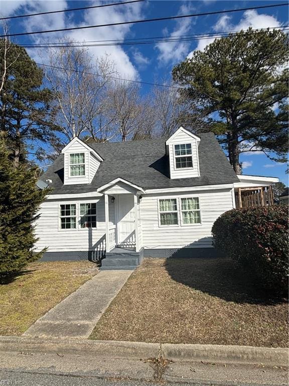 new england style home with a shingled roof