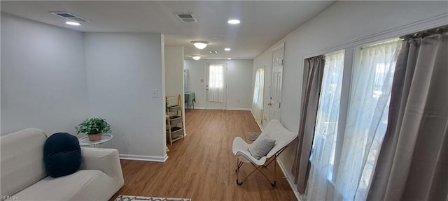 interior space featuring recessed lighting, visible vents, baseboards, and wood finished floors