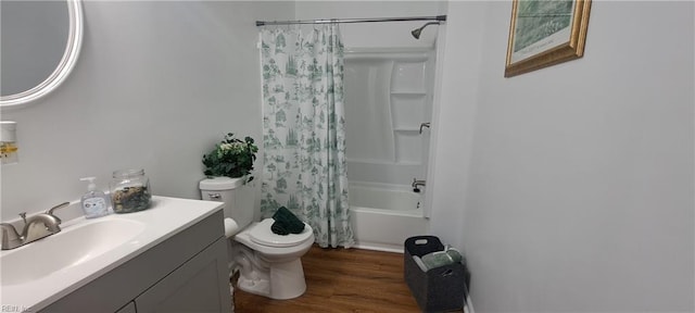 full bath with toilet, shower / tub combo with curtain, wood finished floors, and vanity