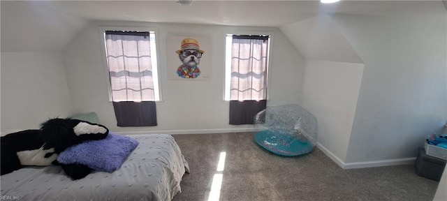 bedroom featuring carpet, baseboards, and vaulted ceiling