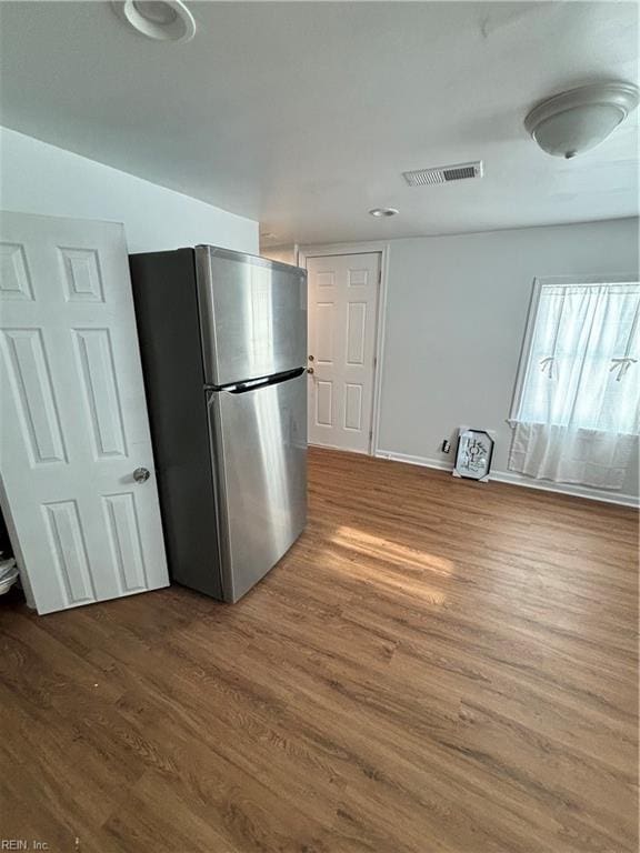 kitchen with dark hardwood / wood-style floors and stainless steel refrigerator