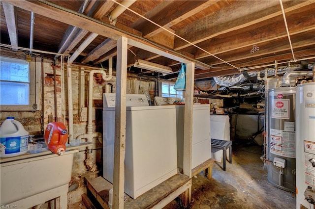 basement with gas water heater, sink, and washer and clothes dryer