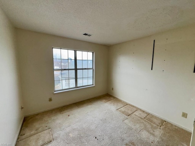 empty room featuring a textured ceiling