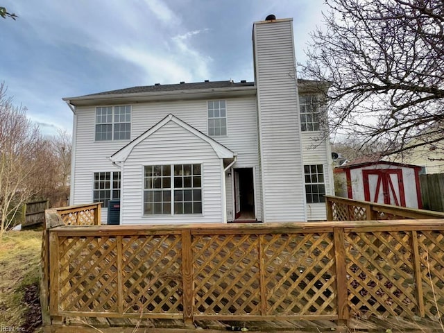 back of property with a storage shed