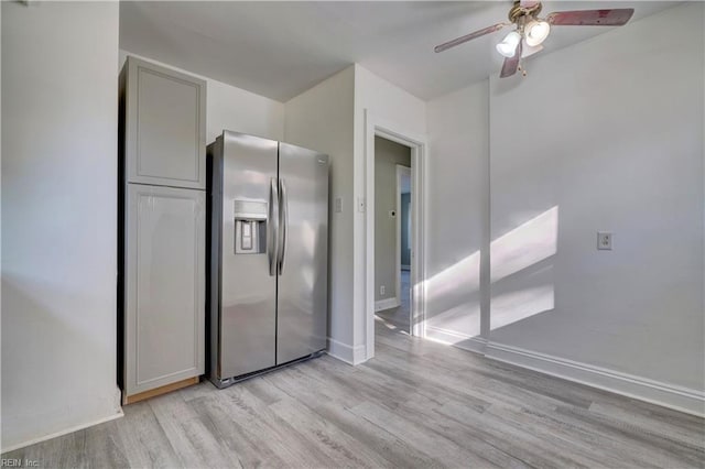 kitchen with gray cabinets, stainless steel fridge, ceiling fan, and light hardwood / wood-style flooring