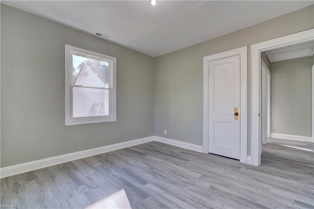 spare room featuring light wood-type flooring