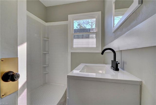 bathroom featuring vanity and a tile shower