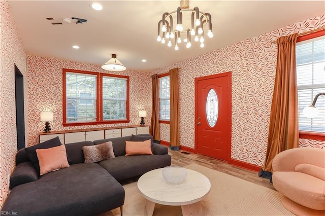 living room with a chandelier and light hardwood / wood-style floors