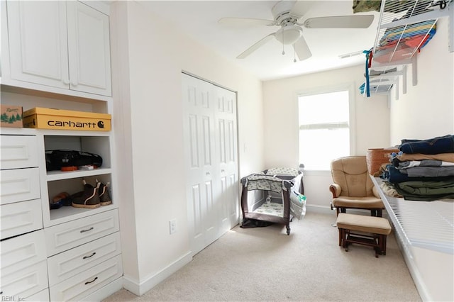 sitting room with light colored carpet and ceiling fan