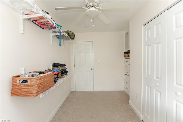 interior space with light colored carpet and ceiling fan