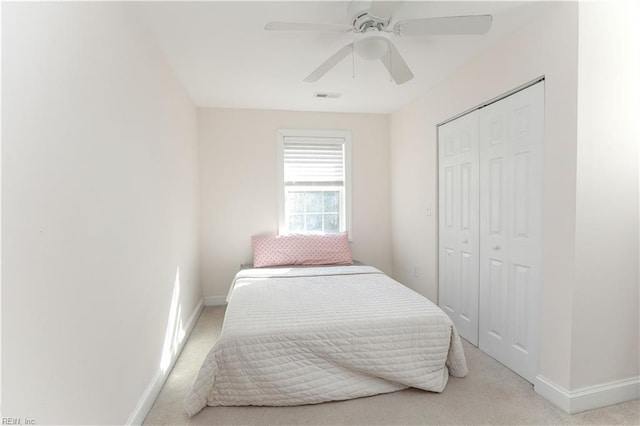 carpeted bedroom with a closet and ceiling fan