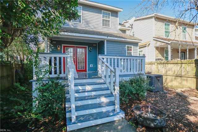 view of front of property featuring central AC unit and a fire pit