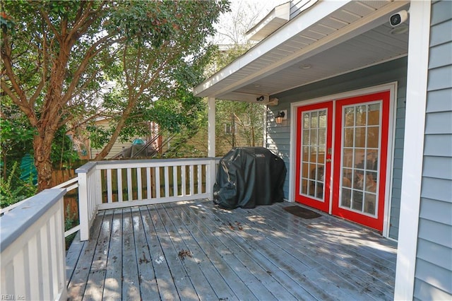 wooden deck featuring a grill