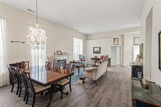 dining space featuring hardwood / wood-style floors and a chandelier