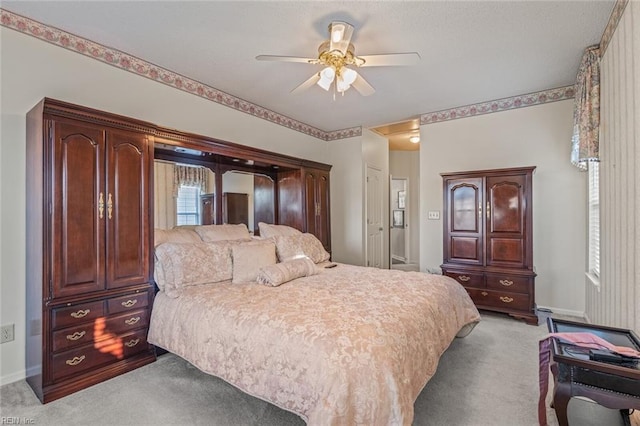 carpeted bedroom featuring ceiling fan