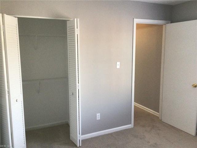 unfurnished bedroom with carpet floors and a closet