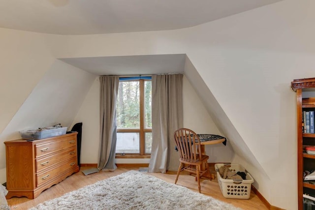 interior space with vaulted ceiling and light hardwood / wood-style floors