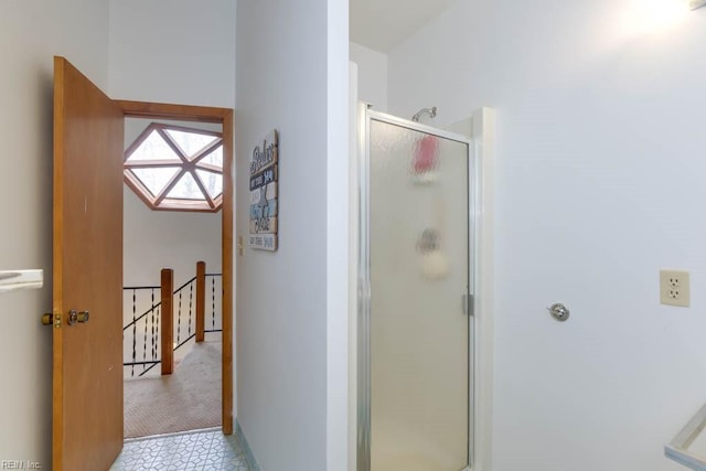 bathroom featuring a shower with shower door