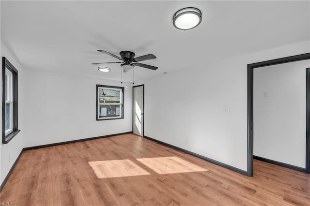 empty room with light hardwood / wood-style flooring and ceiling fan