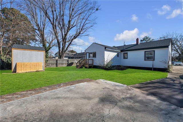 exterior space featuring a yard, a storage unit, and a patio area