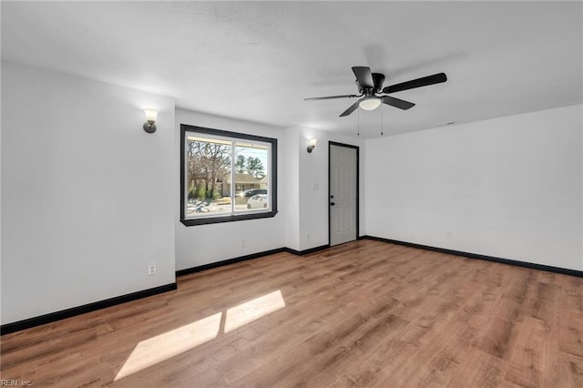 empty room featuring light hardwood / wood-style flooring and ceiling fan