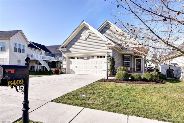 view of front of home featuring central AC, a garage, and a front yard