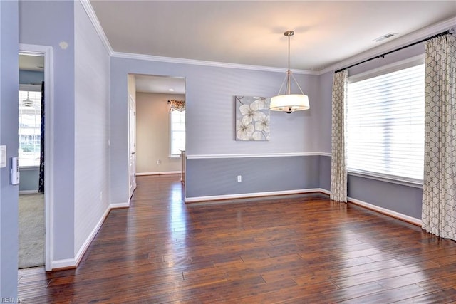 spare room with dark wood-type flooring and ornamental molding