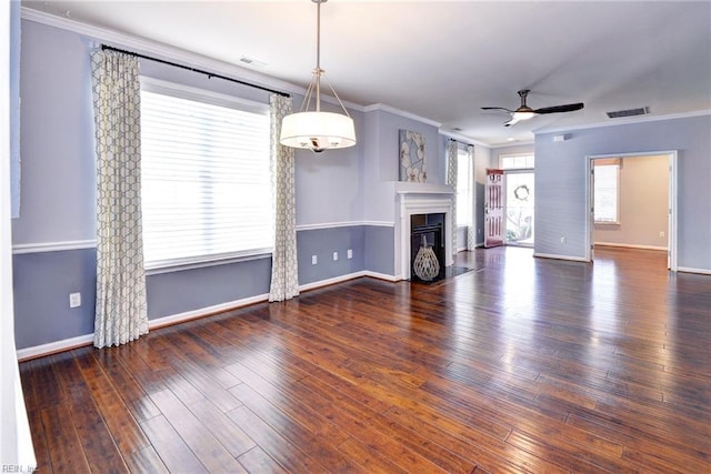 unfurnished living room featuring crown molding, dark wood-type flooring, and ceiling fan