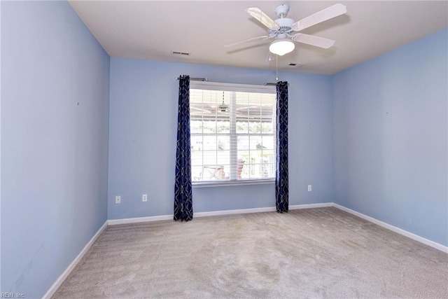 empty room featuring light carpet and ceiling fan