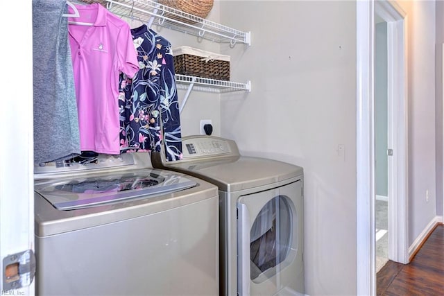 washroom featuring dark wood-type flooring and washer and dryer