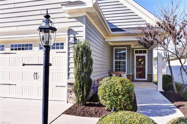 view of exterior entry with a garage