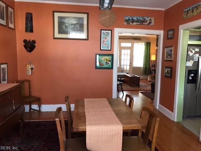 dining area featuring wood-type flooring and ornamental molding